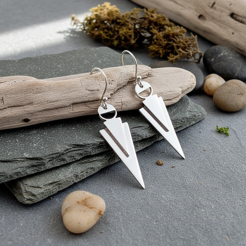 Arrowhead Sterling Silver Earrings on natural surface