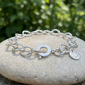 Curved Link bracelet outdoors from a low side angle