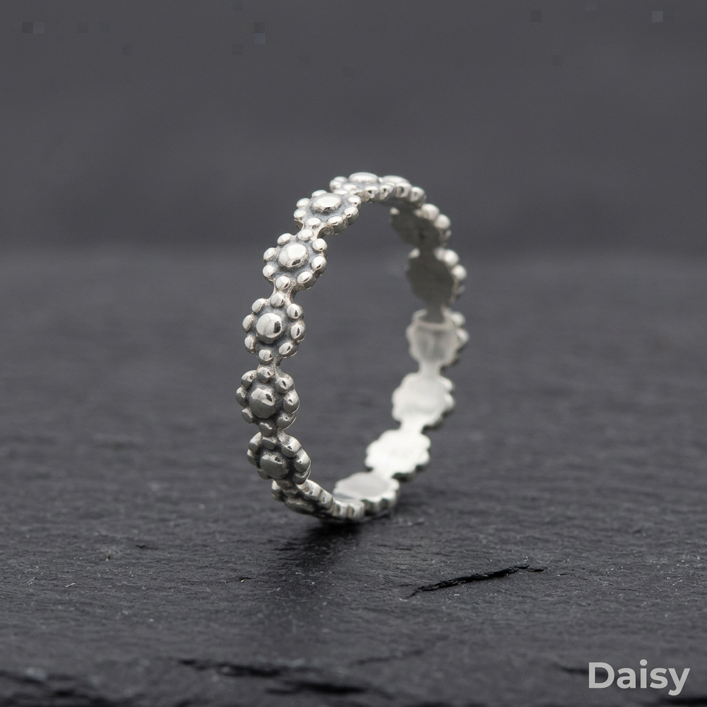 Daisy stacking ring on slate, rebuilt from the real reference photos