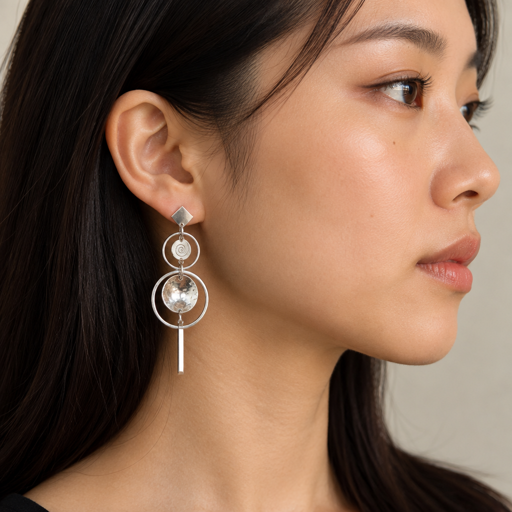 East Asian model wearing the layered silver drop earring