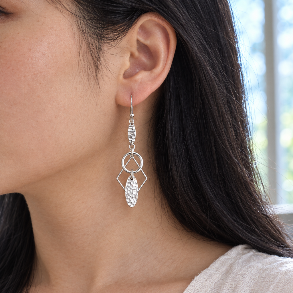 Model wearing Lyra sterling silver drop earrings