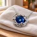 Entwined pendant on linen with fine twist chain