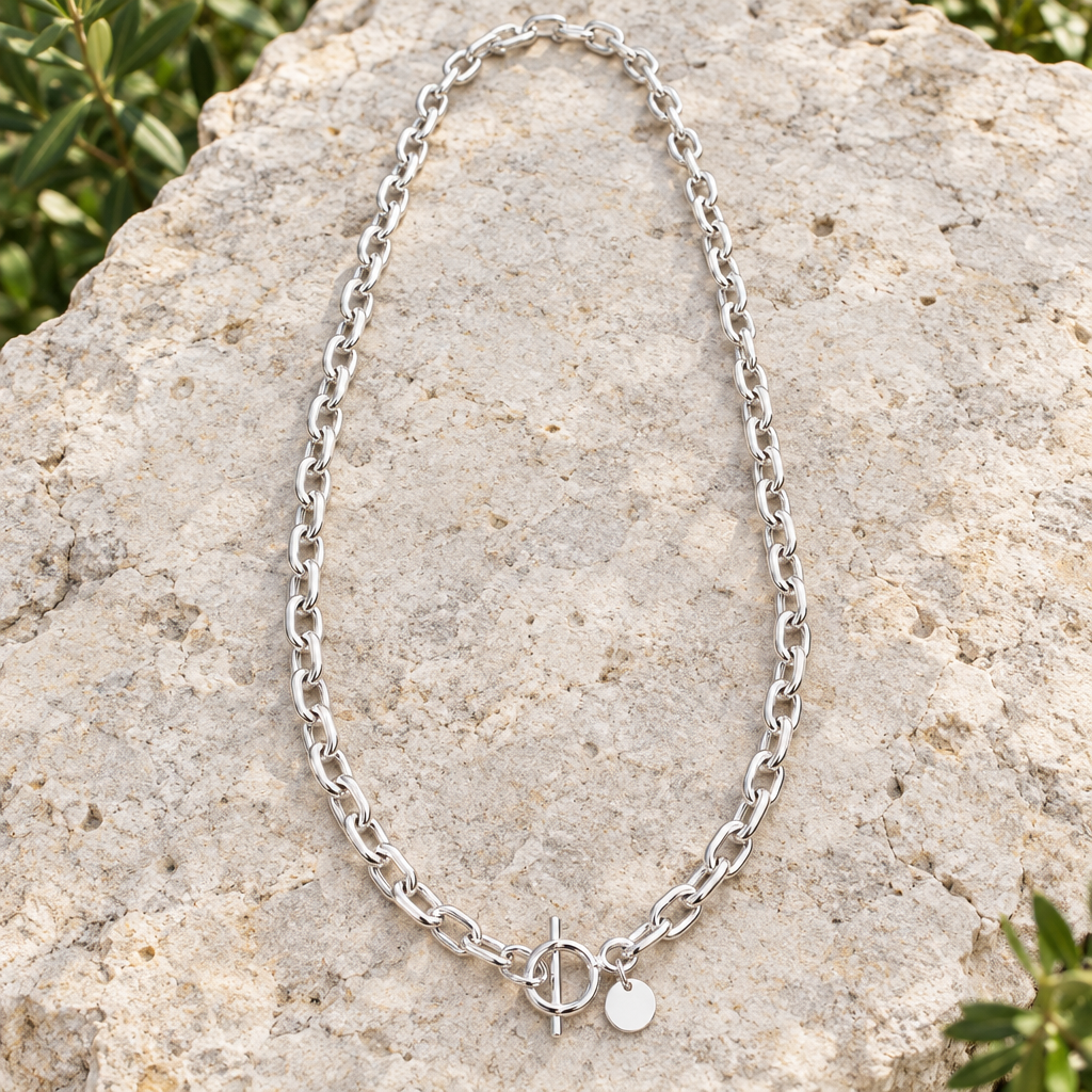 Long anchor chain necklace arranged on outdoor limestone