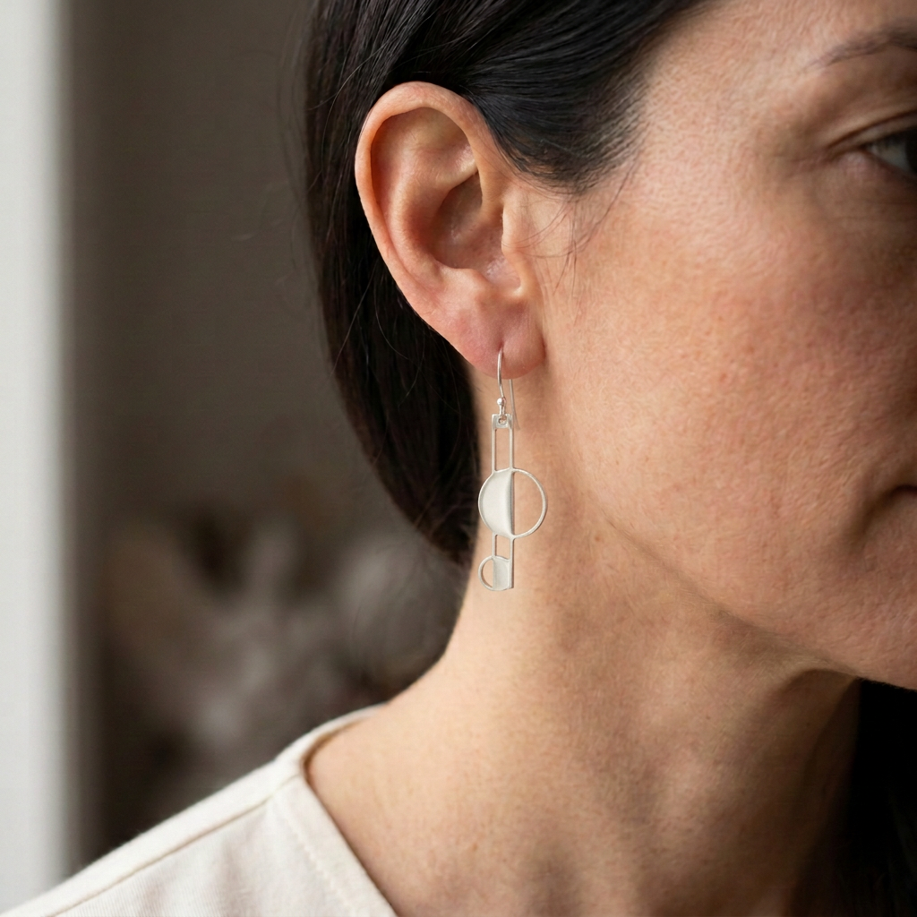 Model wearing a further reduced polished silver earring