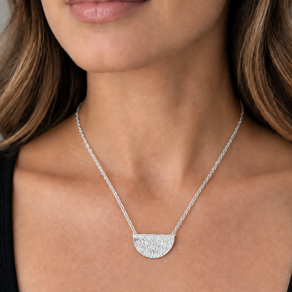 Model wearing the silver semicircle spiral pendant