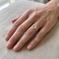 Open circle silver ring on a slender finger