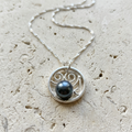 Pendant on a natural limestone surface