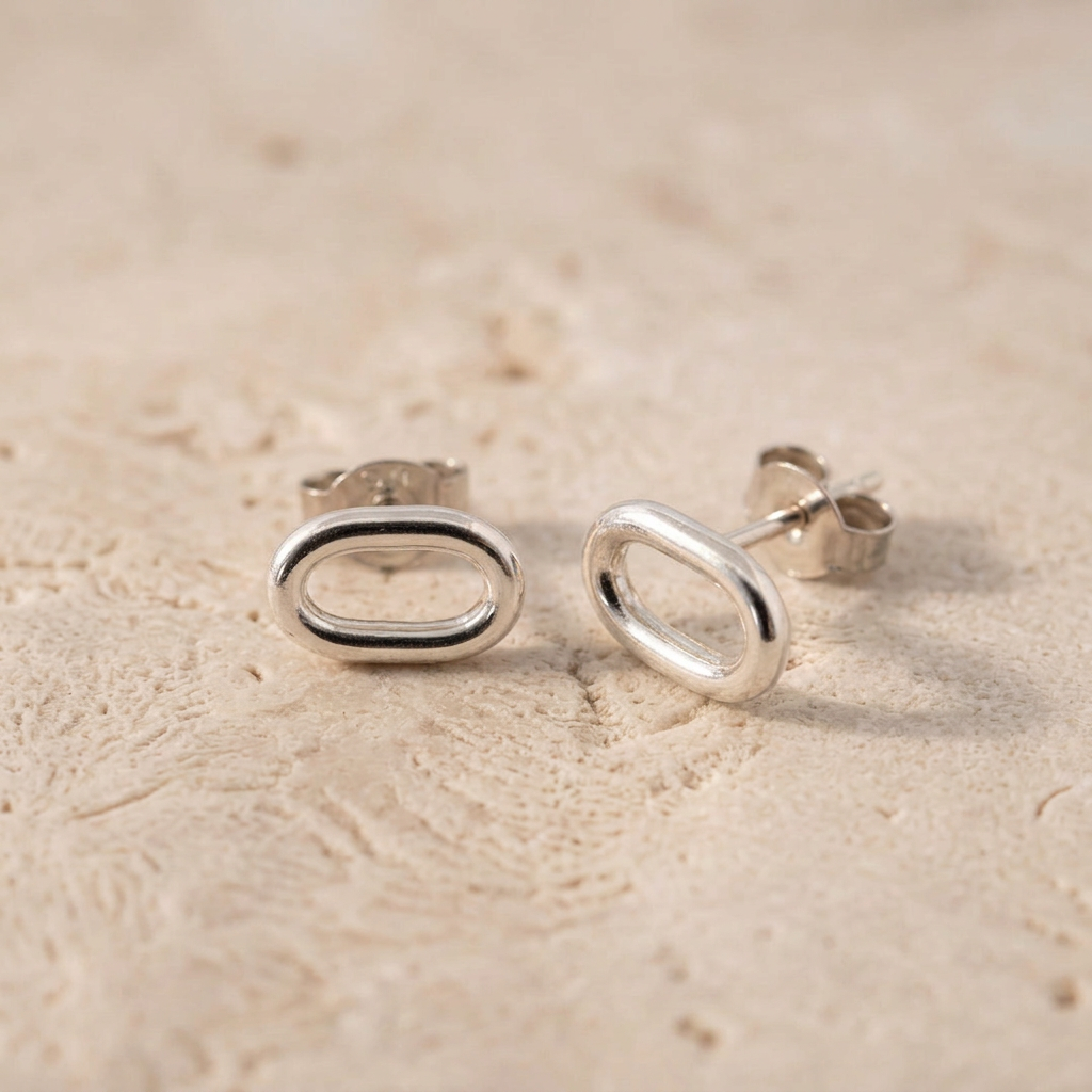Retouched silver stud earrings on natural stone