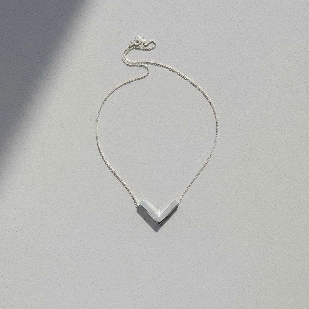 Silver chevron pendant - flat lay