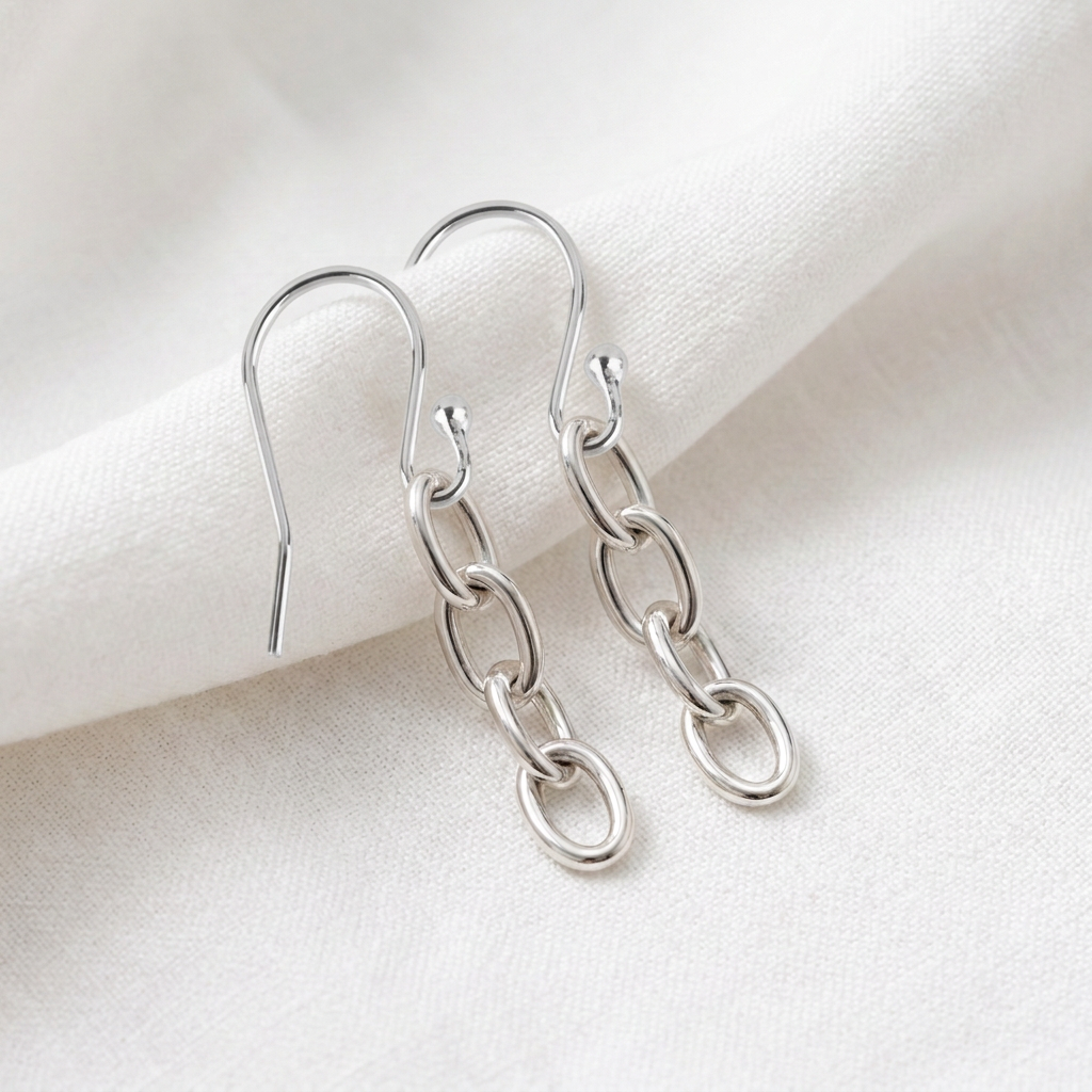 Silver link earrings on folded white fabric, revised with plain ball-end ear wires