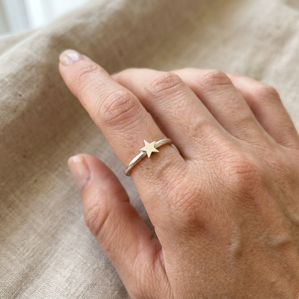 Silver star ring on a slender finger