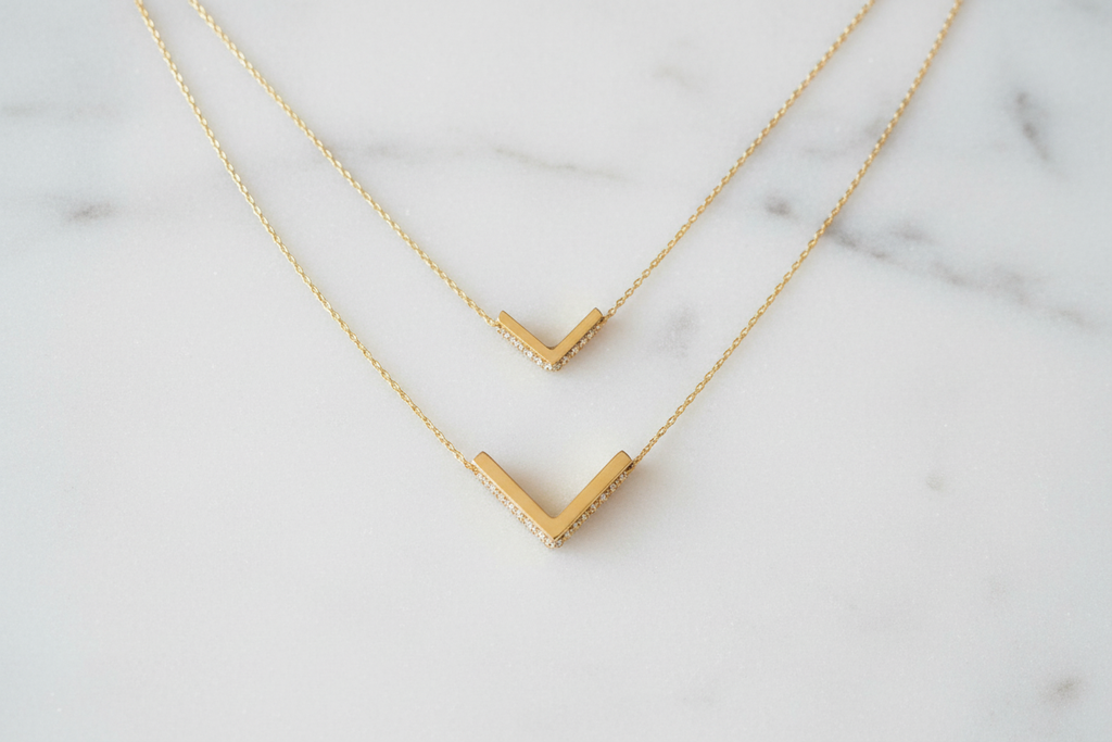 Small and large gold chevron pendants size comparison