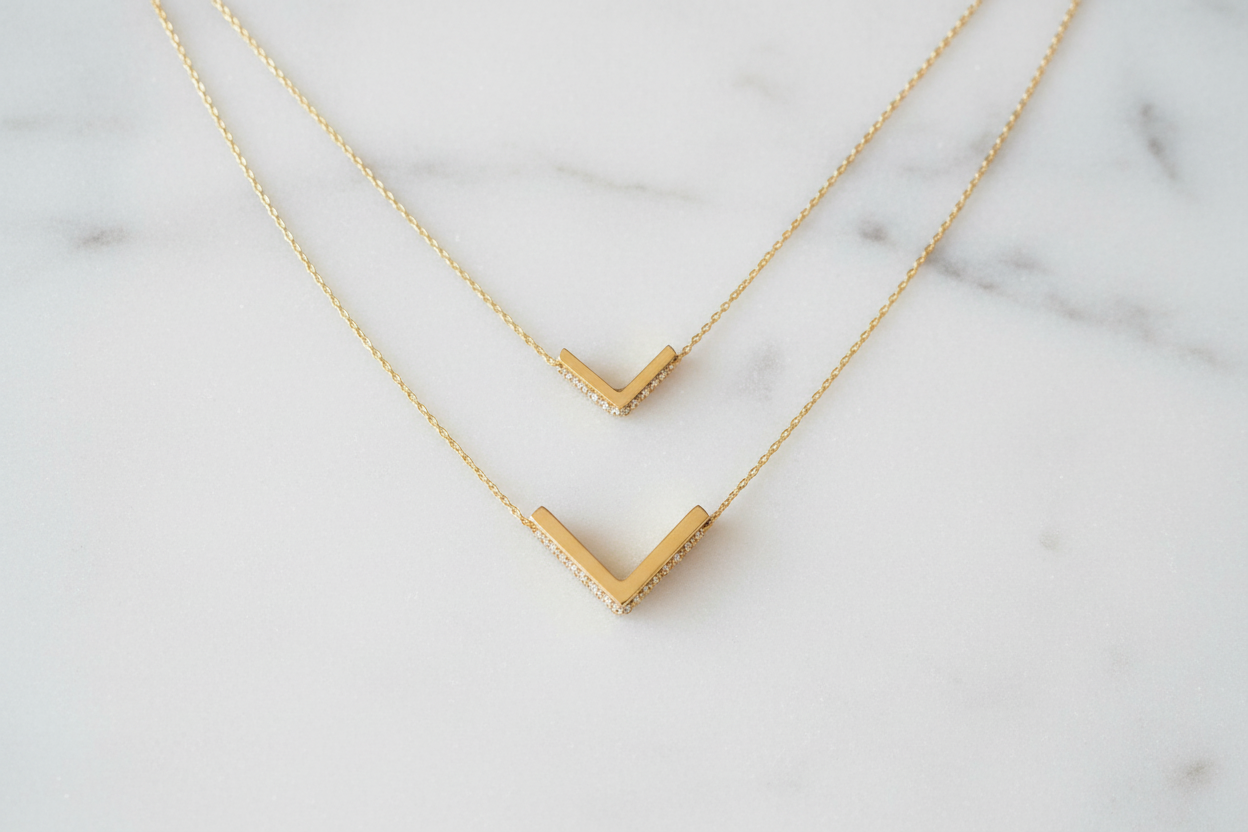 Small and large gold chevron pendants size comparison