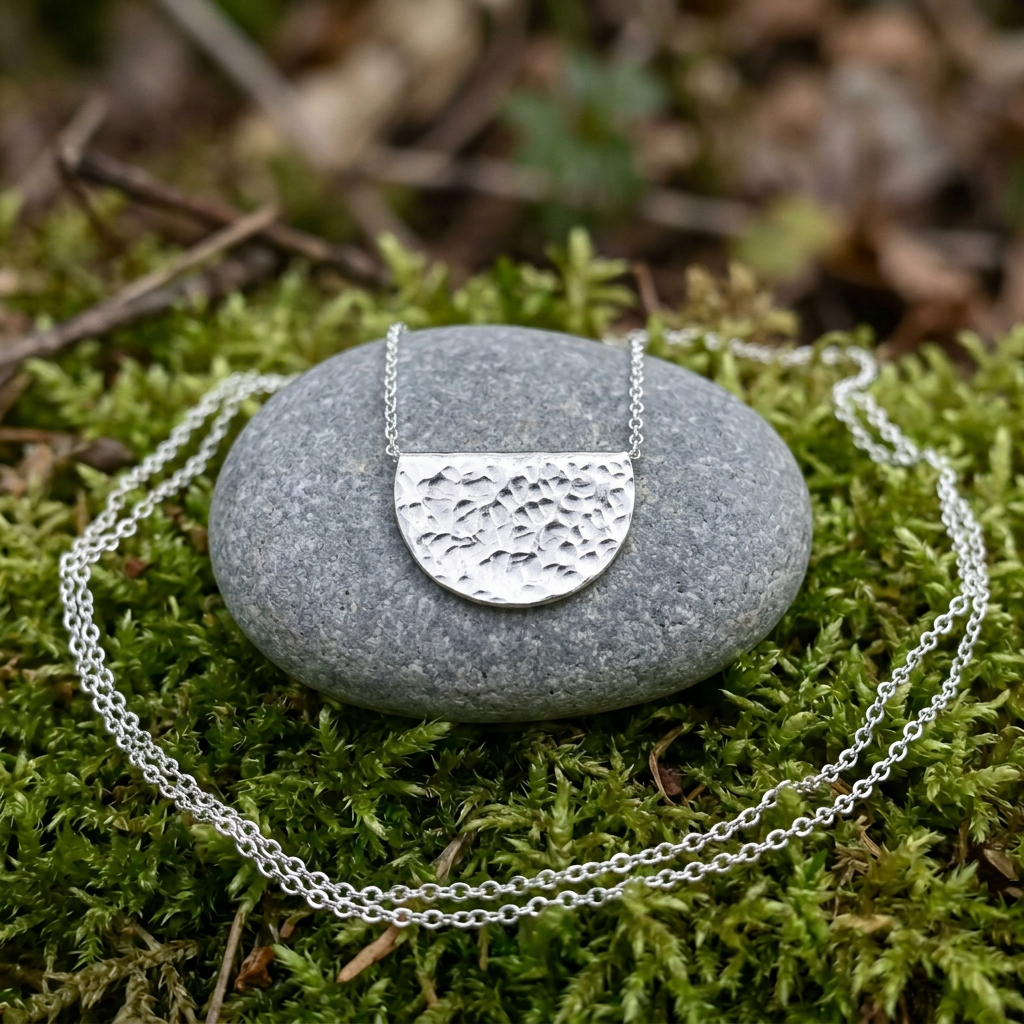 Smaller pendant on a mossy pebble