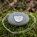 Smaller pendant on a mossy pebble
