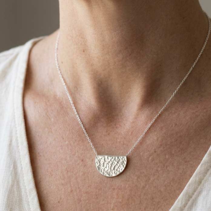 Smaller pendant worn by a woman
