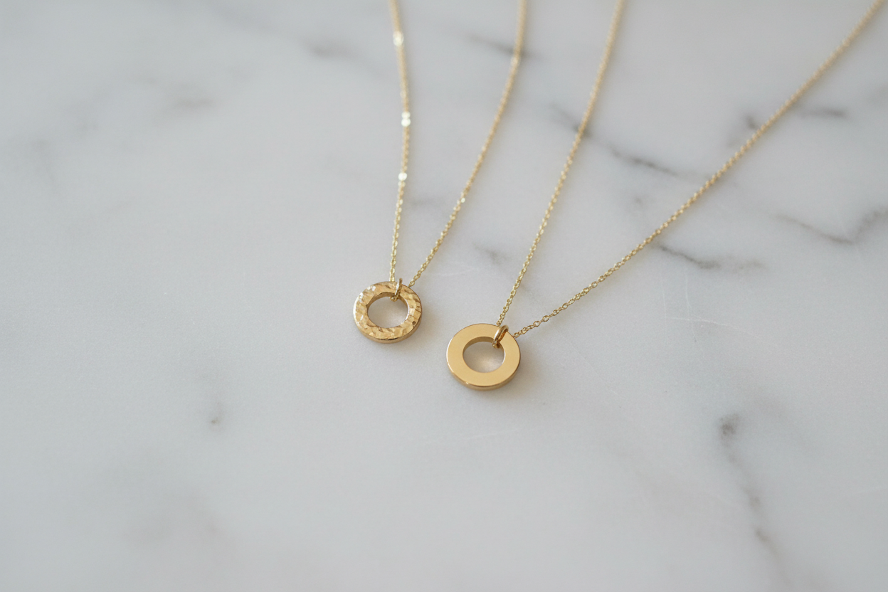 Two flat gold washer pendants side by side comparison