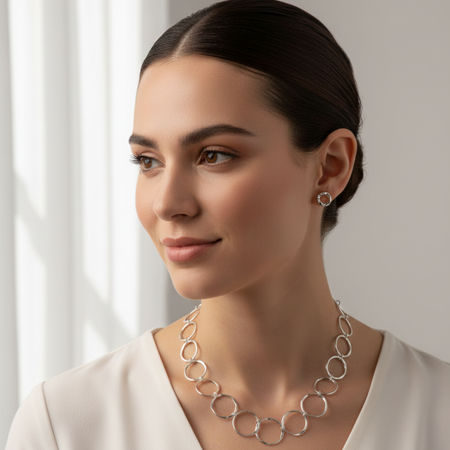 Woman wearing Cornered Ring Earrings and larger Necklace