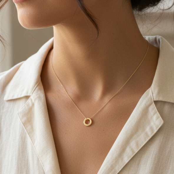 Woman wearing smooth gold circle pendant