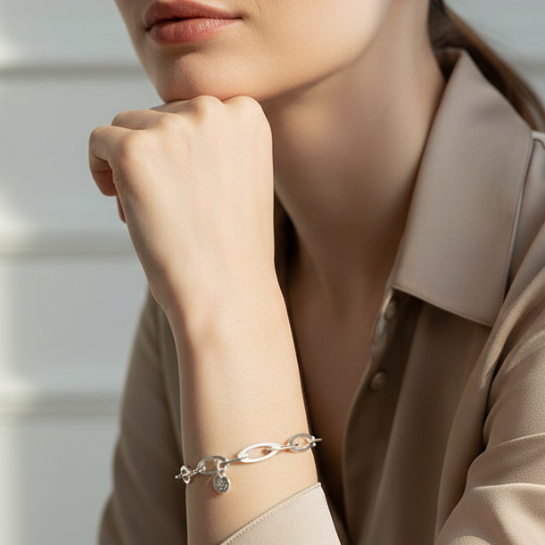 Woman with chin resting on hand wearing Oval Link Chain Sterling Silver Bracelet