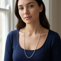 Younger adult dark-haired model wearing the short-link necklace