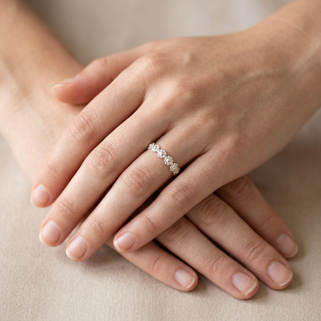 Your silver flower ring on slender fingers, with one hand resting over the other