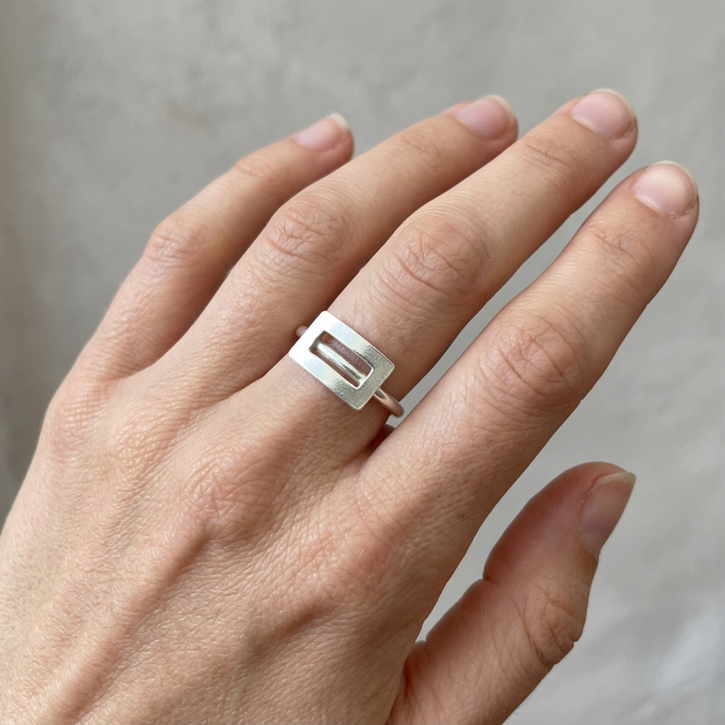 Your silver ring on a young adult’s slender hand